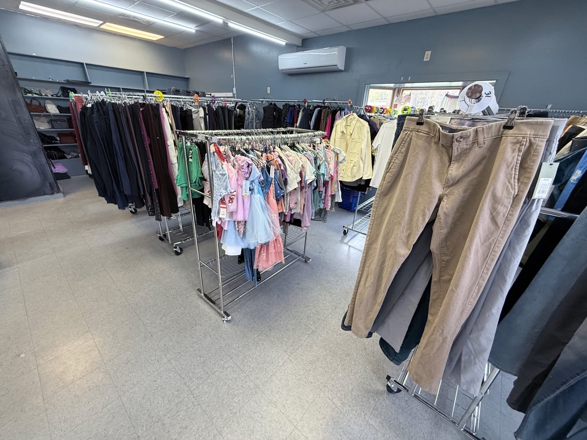 Racks of women's, men's, and kids' clothing inside the store